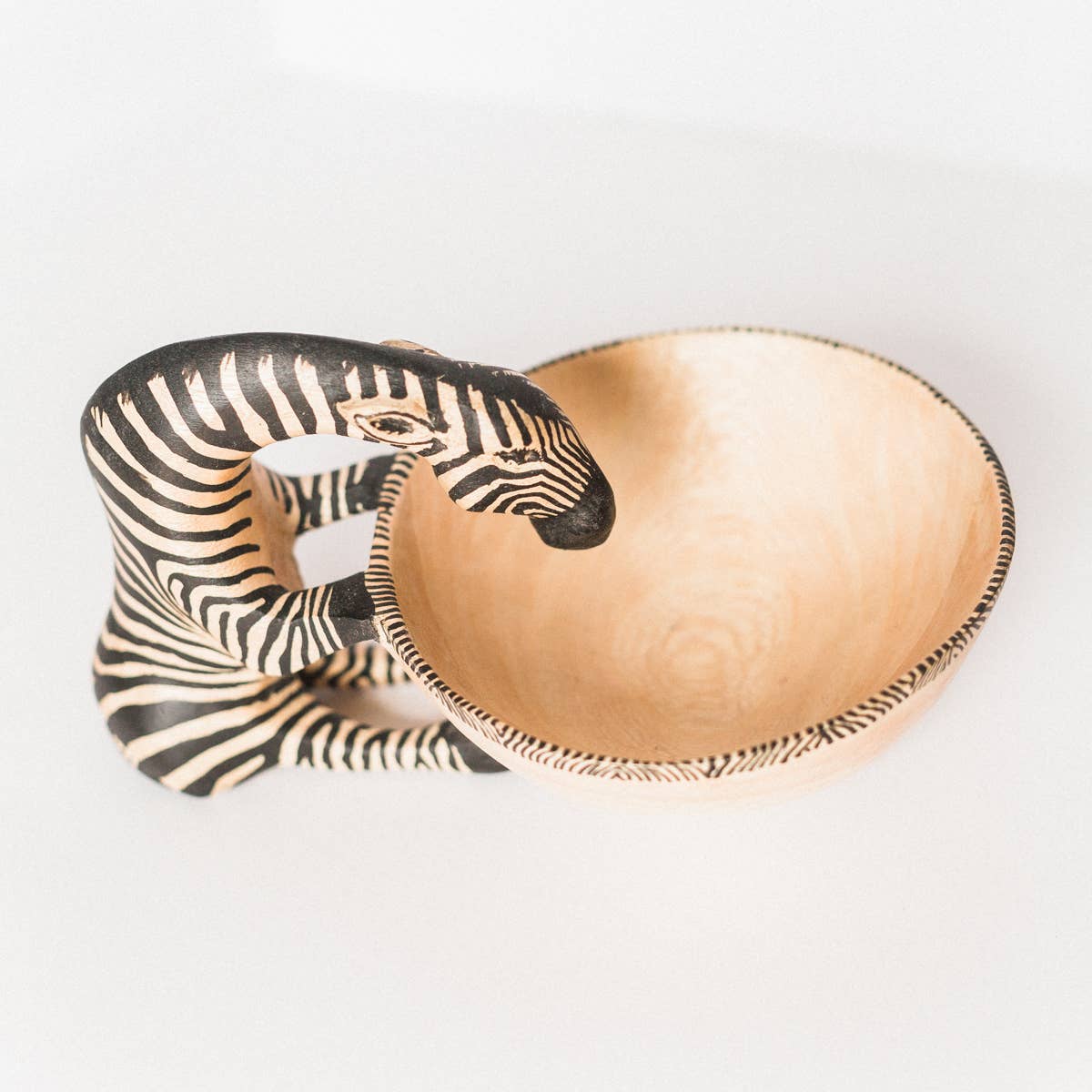 Decorative trinket bowl with zebra design on a white background