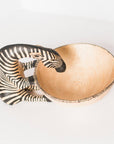 Decorative trinket bowl with zebra design on a white background