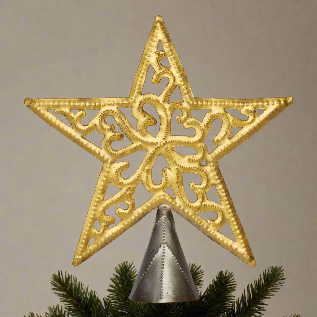 Decorative gold star tree topper on a plain background