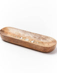 Wooden incense holder with decorative moon design on a white background