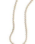 Pearl necklace with gold accents on a white background