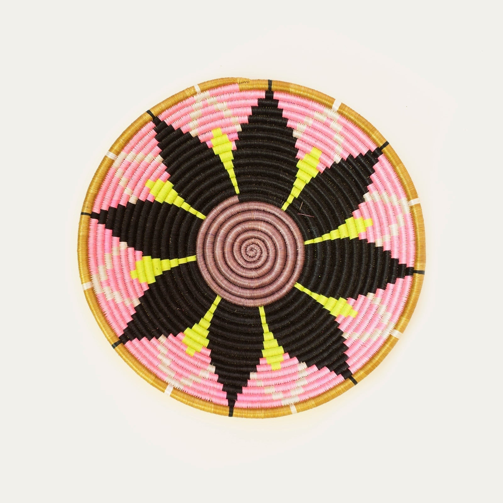 Decorative woven plate with pink, black, and yellow pattern on a white background