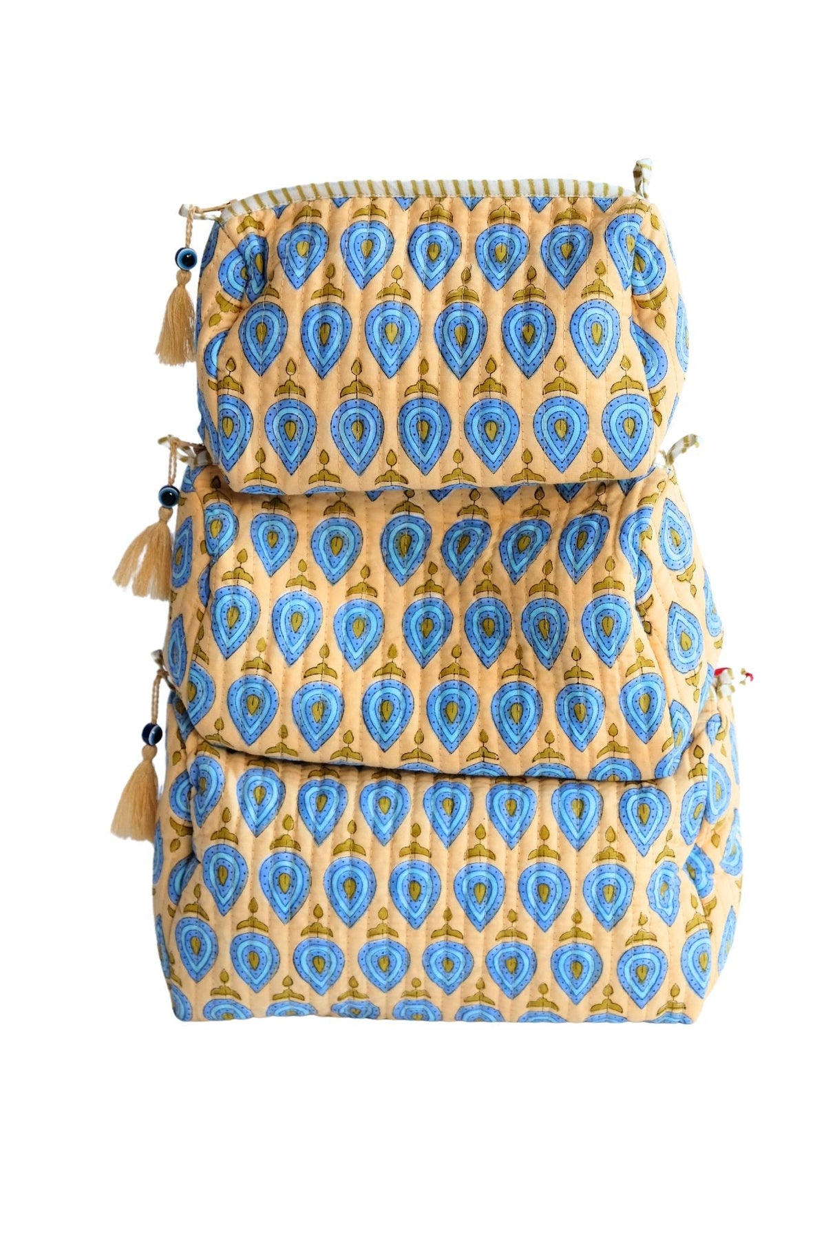 Stack of three patterned bags with tassels on a white background