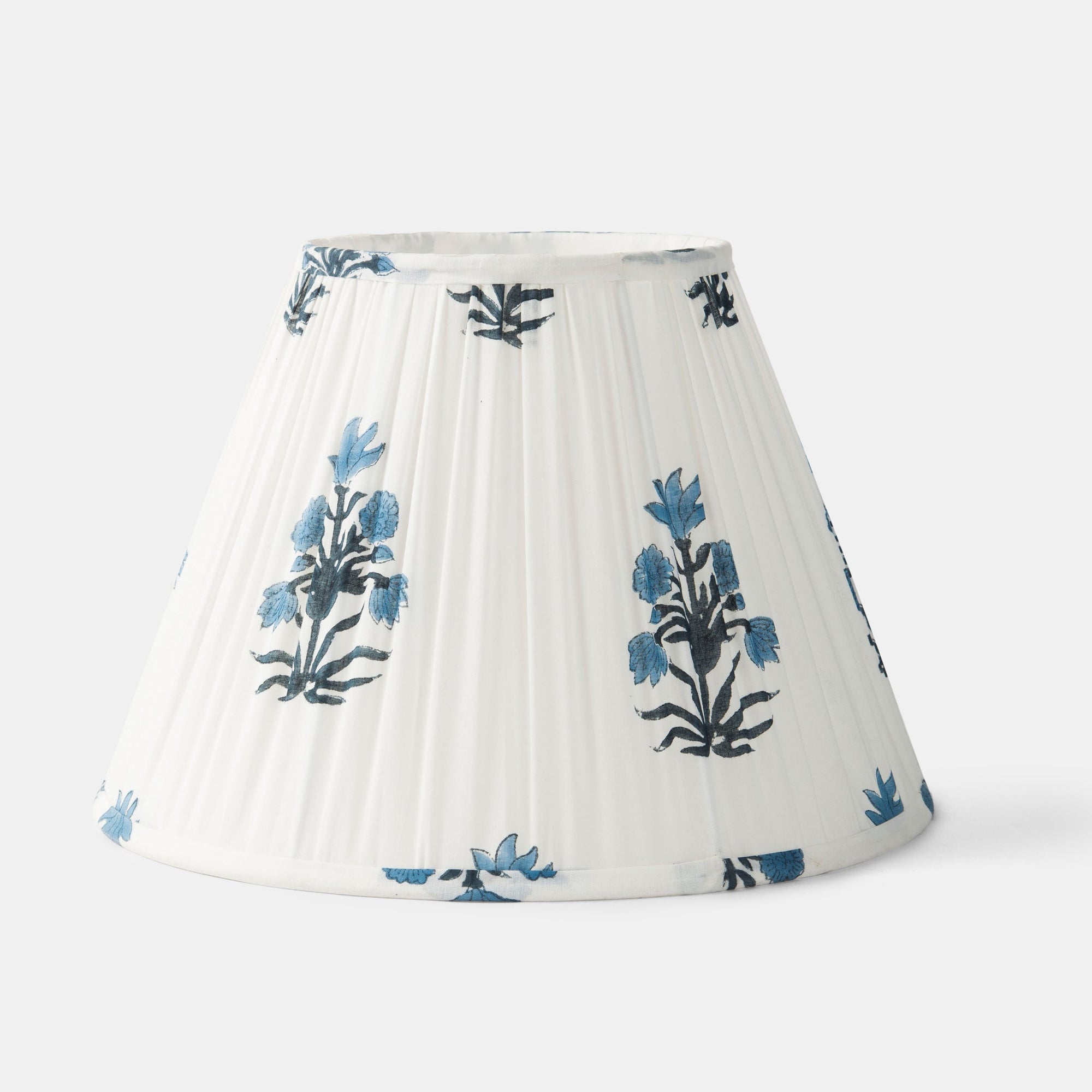 White pleated lampshade with blue floral patterns on a white background