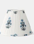 White pleated lampshade with blue floral patterns on a white background