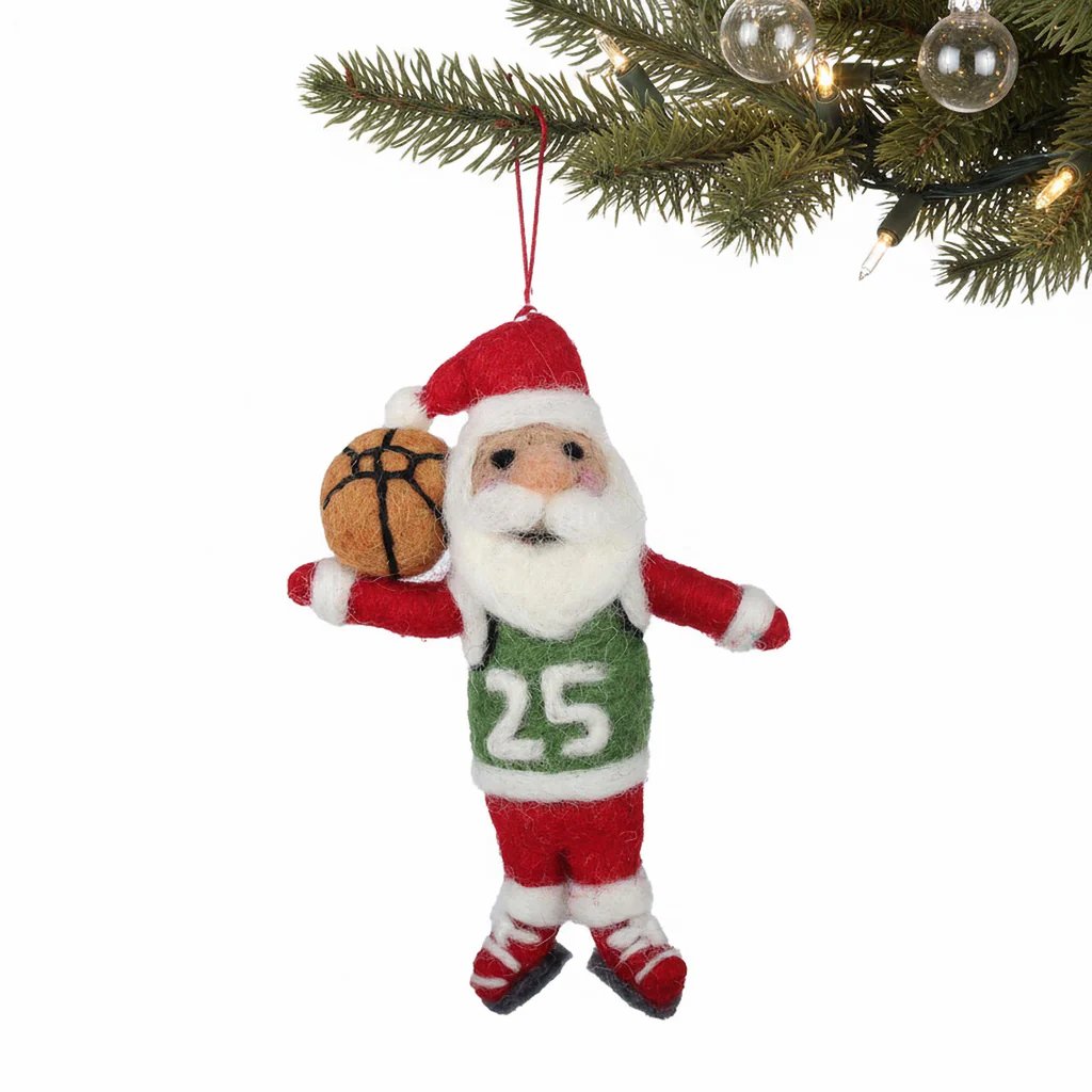 Santa Claus ornament holding a basketball hanging from a christmas tree branch