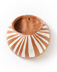 Ceramic bowl with sunburst design on a white background