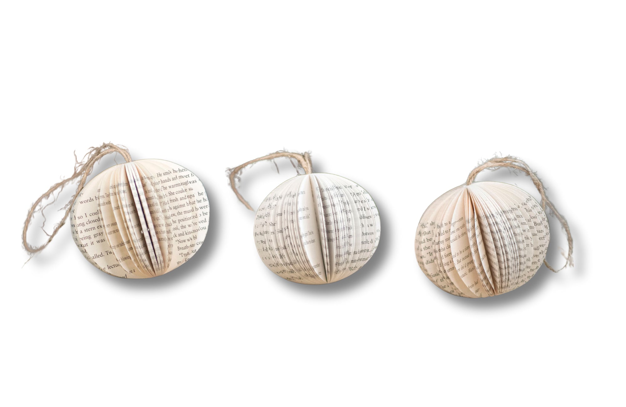 Three decorative book page ornaments on a white background