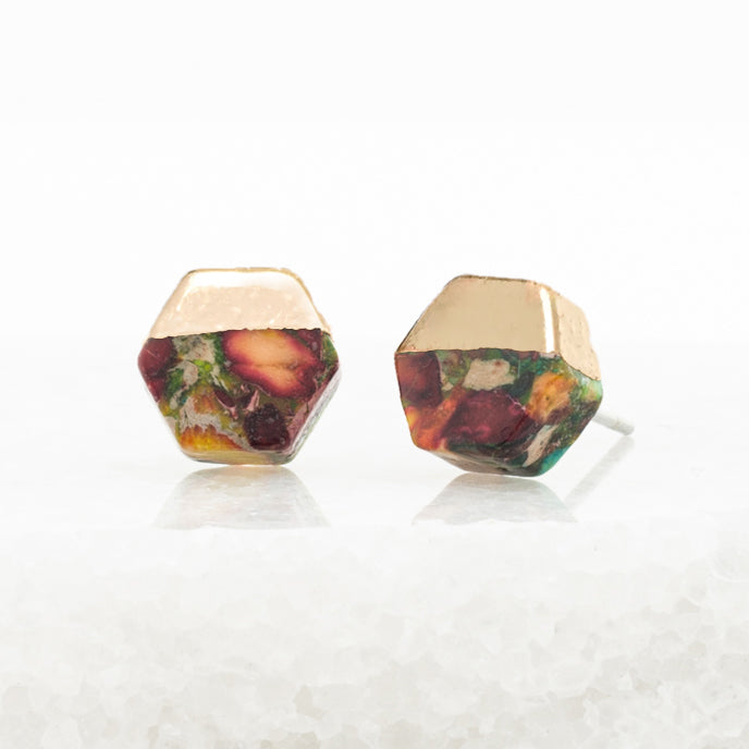 Hexagonal earrings with multicolored stones on a white background