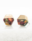 Hexagonal earrings with multicolored stones on a white background