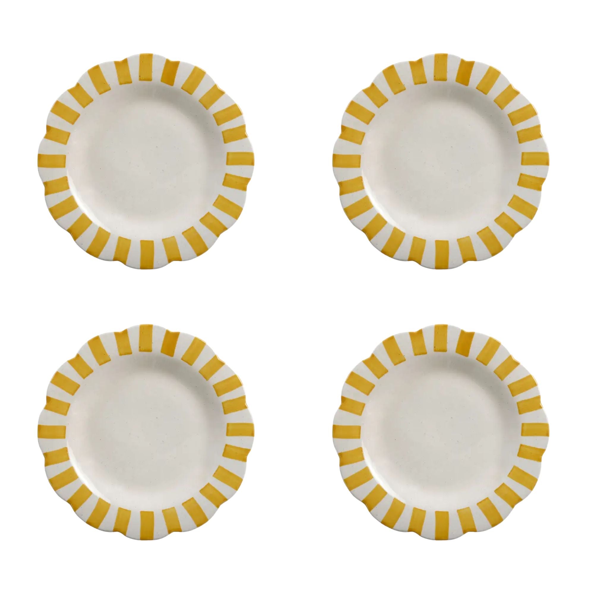 Four white ceramic plates with yellow striped rims on a white background