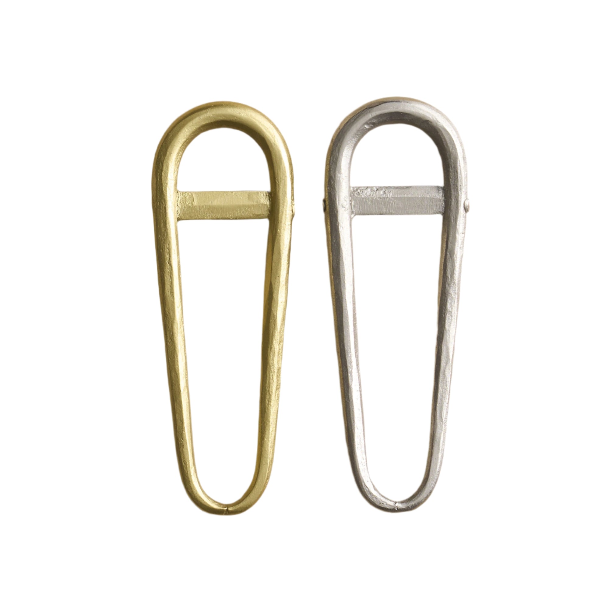 Two snowshoe-shaped bottle openers, one with a brass finish and the other with a pewter finish