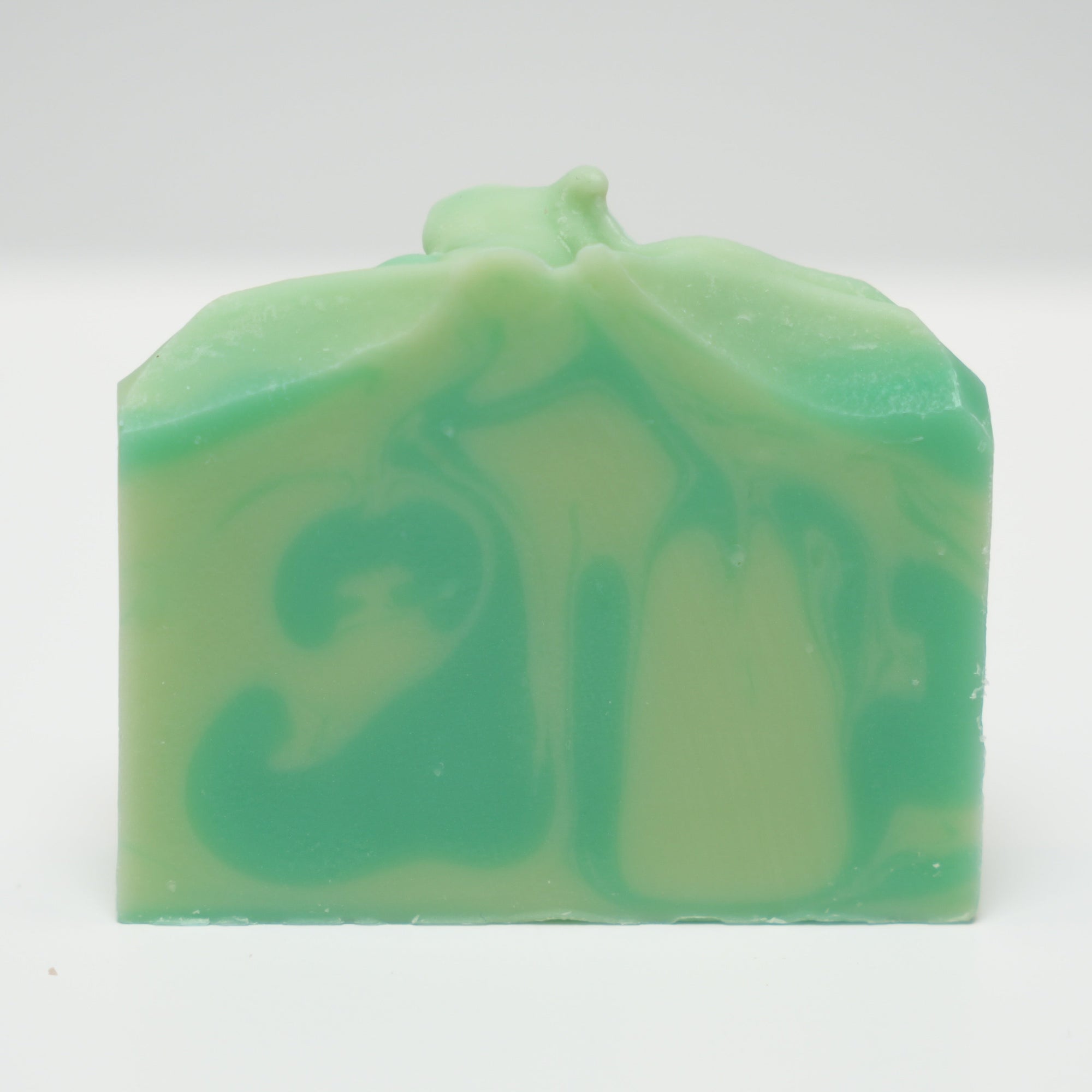 Green and white swirled soap bar on a white background
