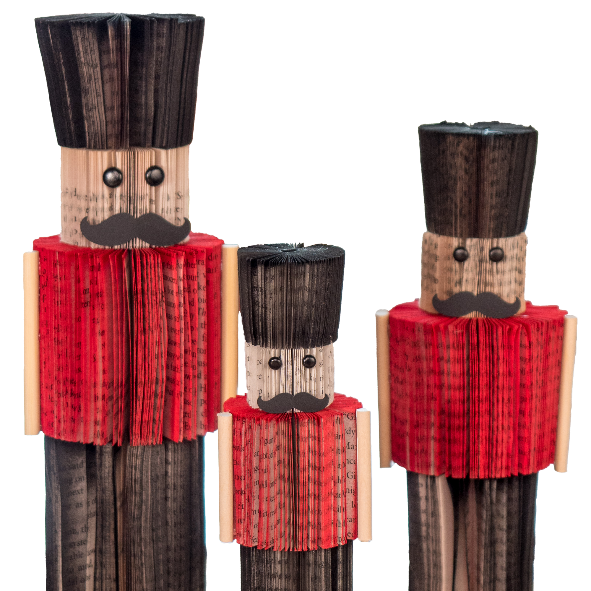 Recycled paper nutcrackers with red jackets and black hats on a white background