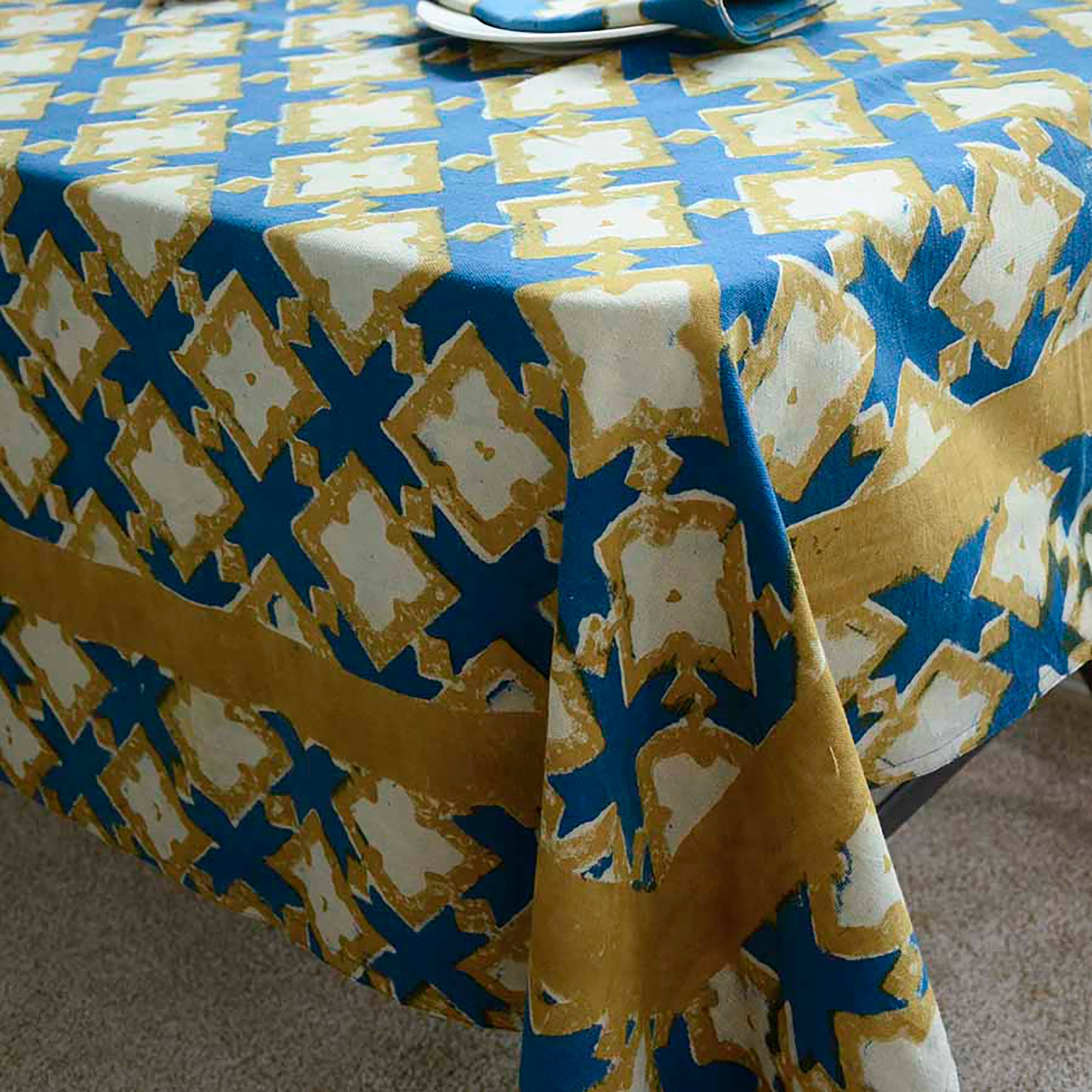 Tablecloth with blue and yellow geometric pattern on a table