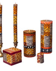Set of decorative candles with African patterns on a white background