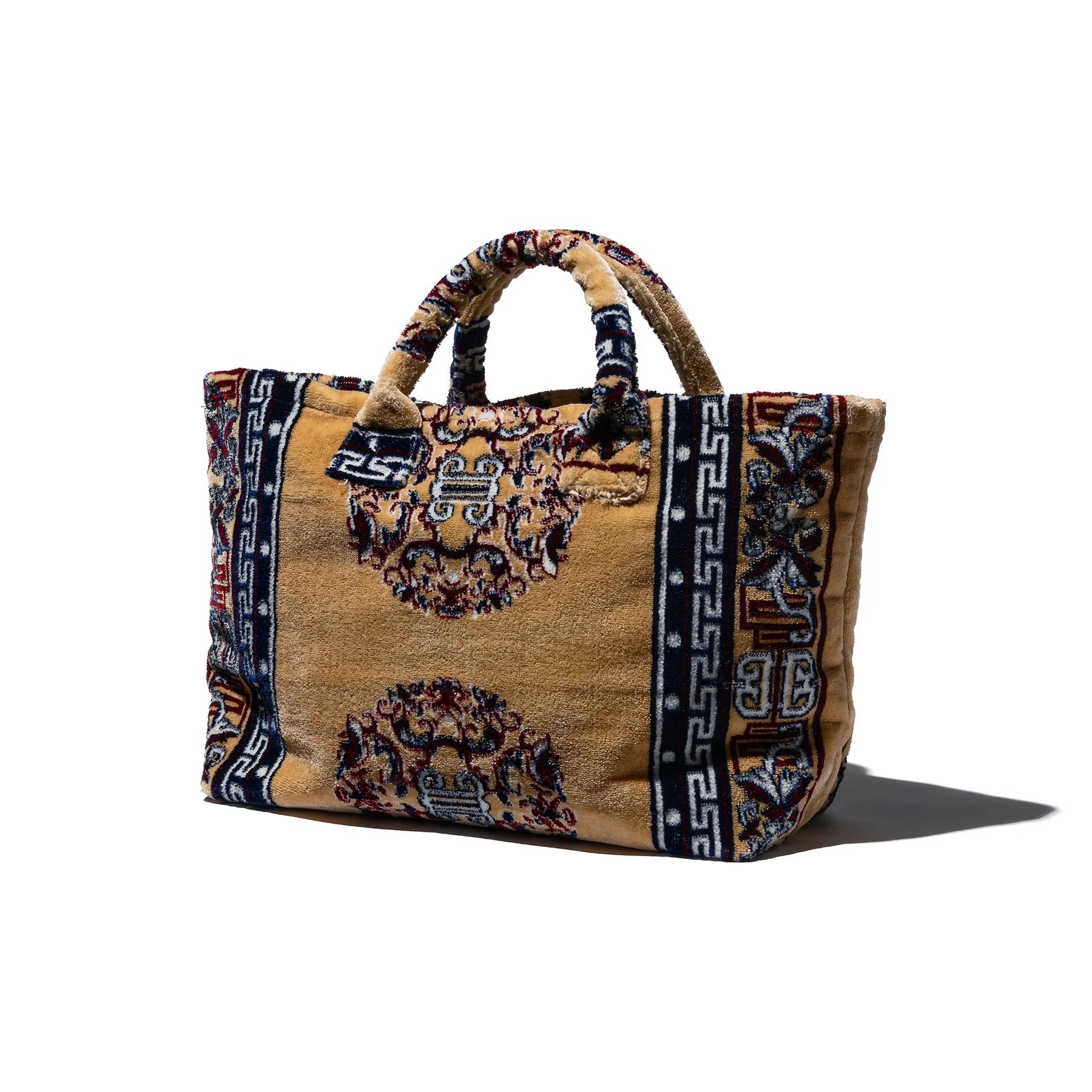 Decorative fabric rug tote bag with patterned design on a white background