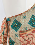Traditional patterned apron on a mannequin against a white background