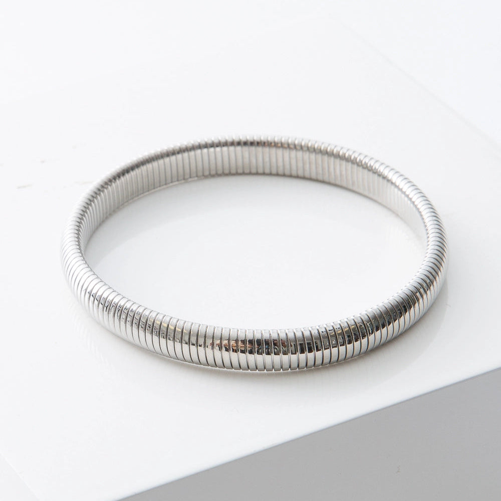Silver bracelet on a white surface