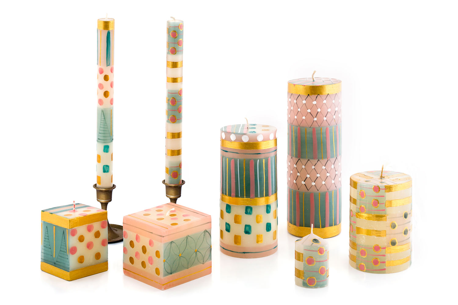 Set of colorful candles with various patterns on a white background