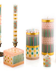 Set of colorful candles with various patterns on a white background