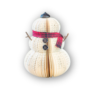 Recycled paper snowman decoration with a red and black plaid paper scarf on a white background
