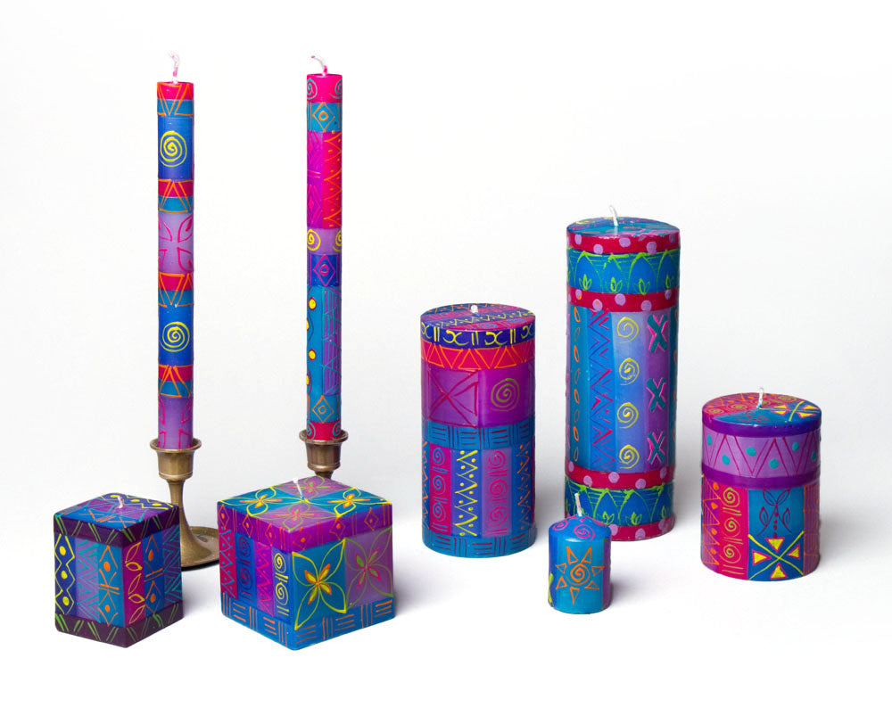 Colorful candle set with geometric patterns on a white background