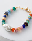 Colorful beaded bracelet with a gold clasp on a white background