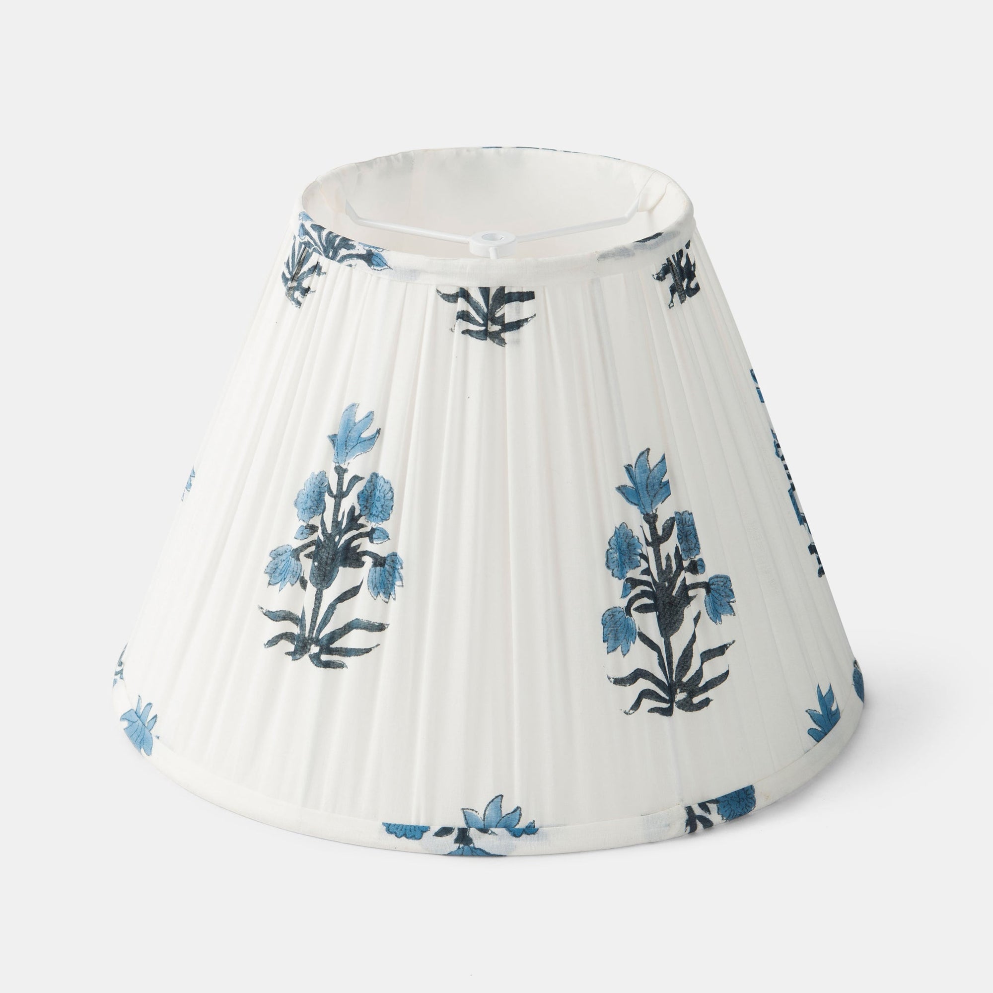 White pleated lampshade with blue floral patterns on a white background