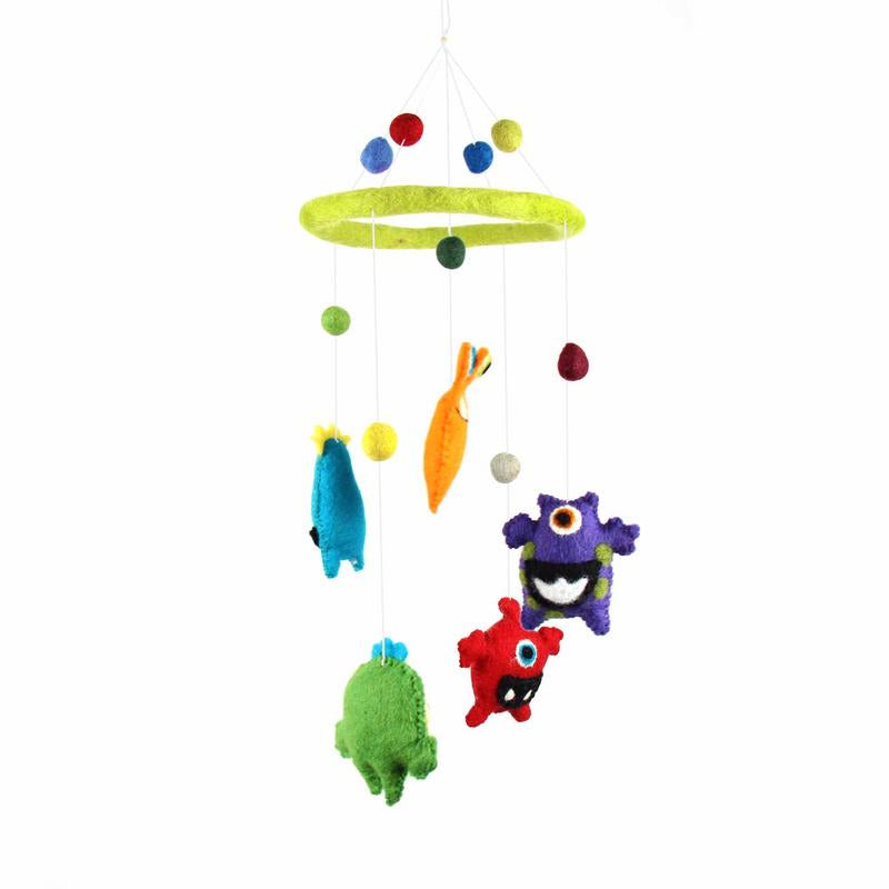 A colorful felt mobile featuring a variety of monster shapes in green, blue, and purple, with a yellow circle at the top and a series of dangling balls.