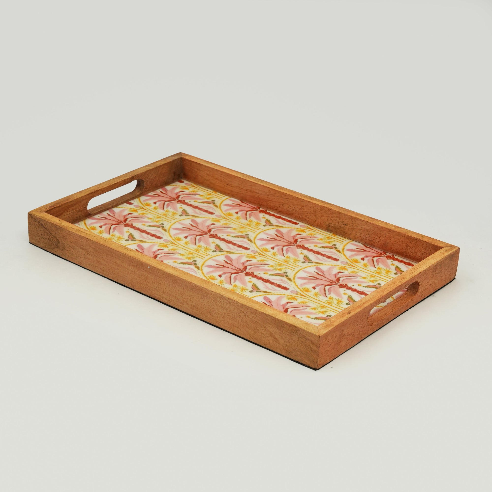 Wooden tray with floral fabric insert on a light gray background