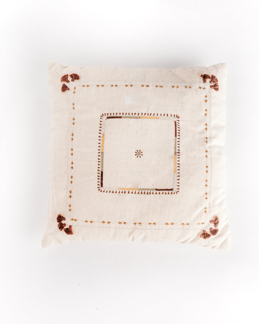 Decorative pillow with embroidered patterns on a white background