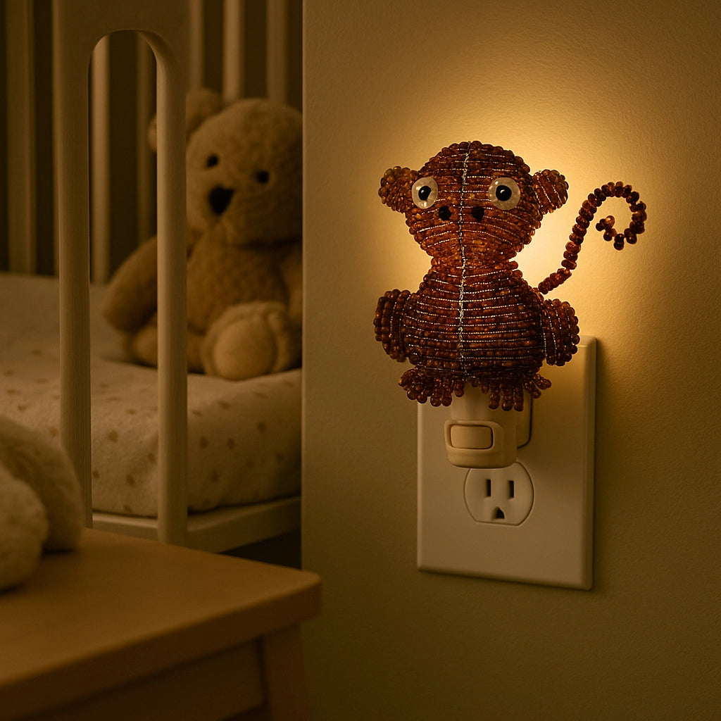 Monkey-shaped night light on a wall switch with a teddy bear in the background.